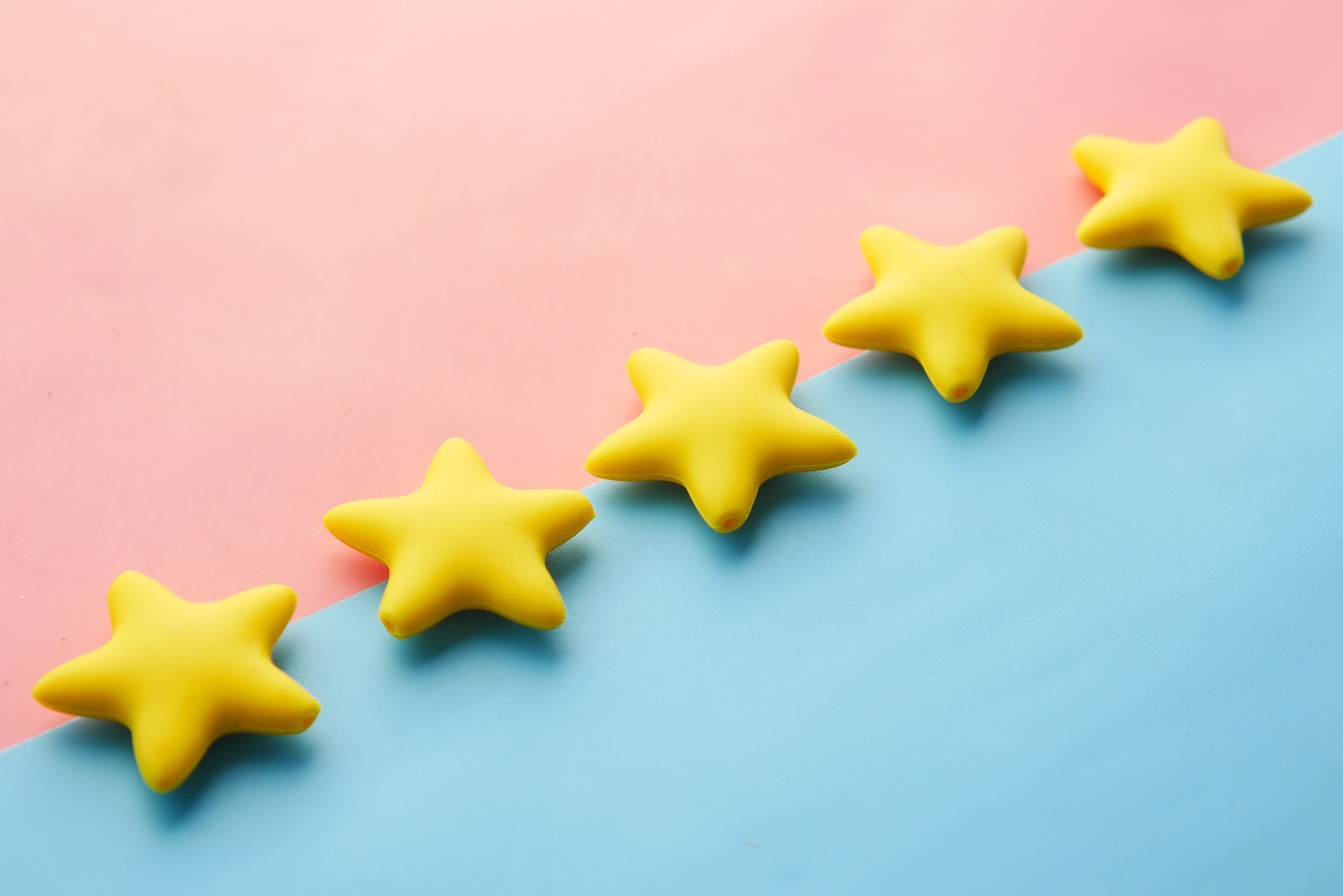 Yellow stars on a pastel background representing a five-star rating or review concept