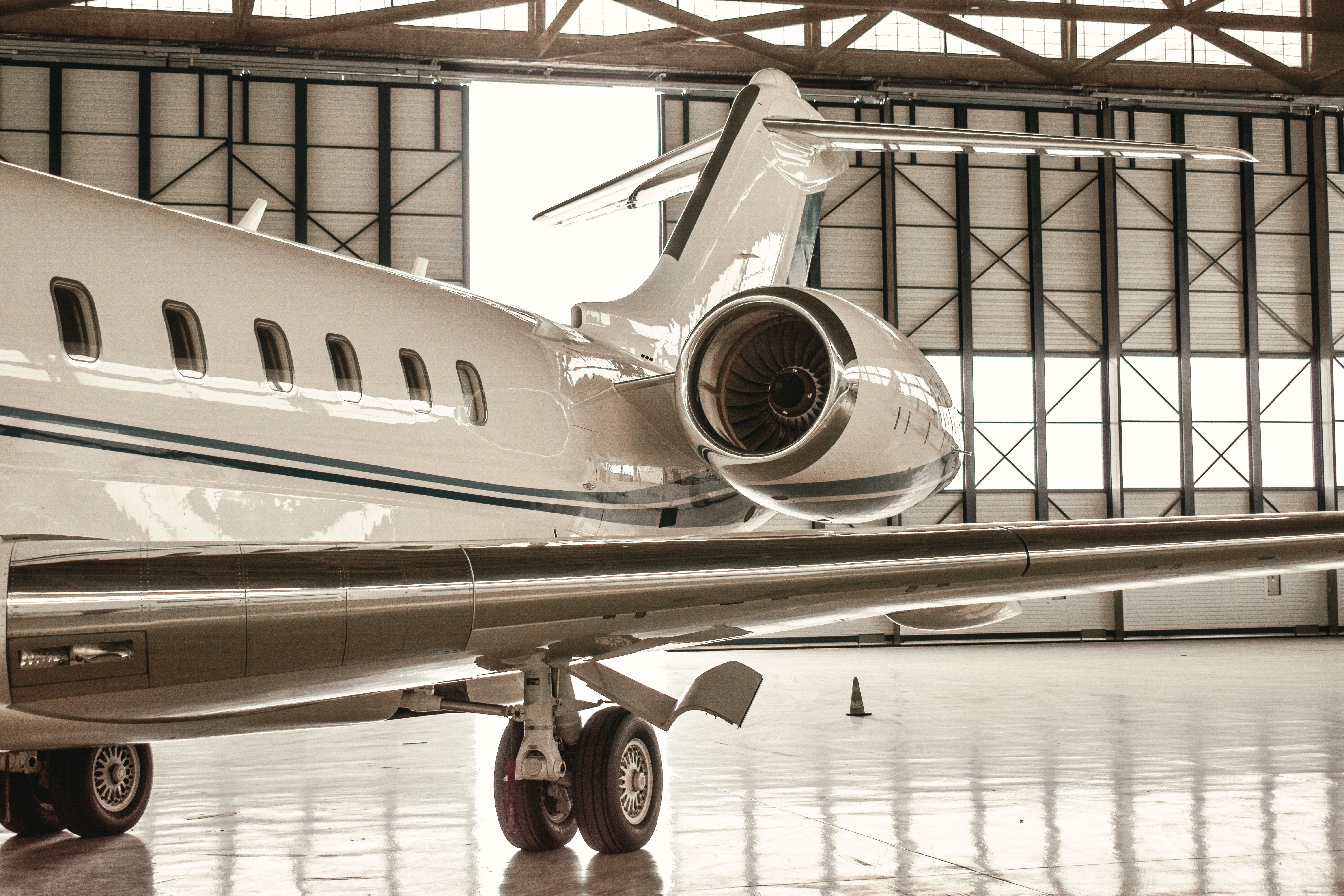 Sleek private jet parked inside a modern hangar in Paris